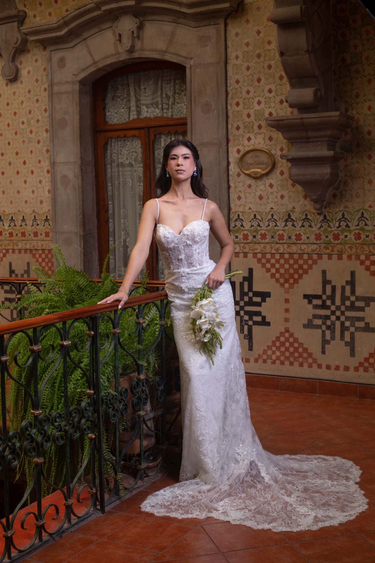 Novia en balcón colonial con vestido de encaje